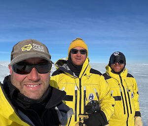 Three men stand on a flat icy plane - the Sorsdal Glacier