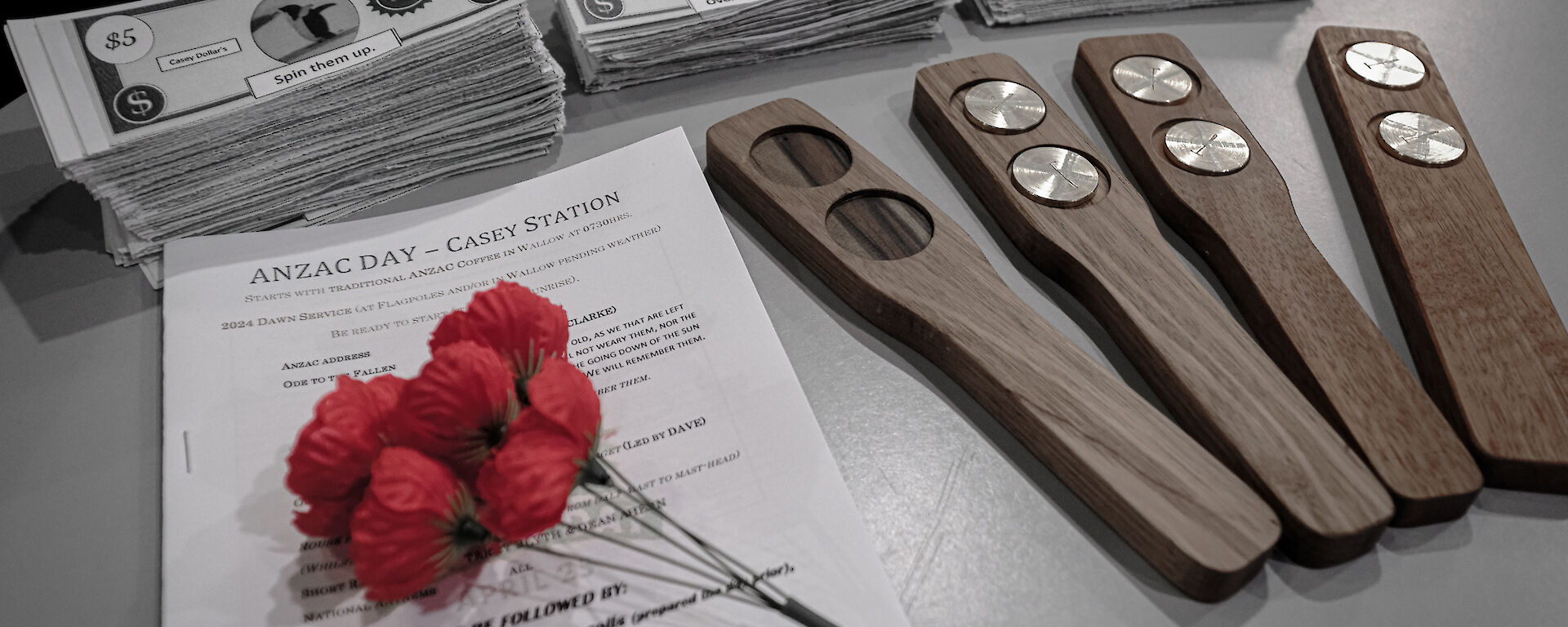red poppies and fake money for playing the traditional two-up on a table
