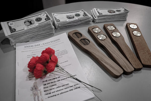 red poppies and fake money for playing the traditional two-up on a table