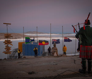 Peter Caithness playing the bagpipes at the start of the Mawson ANZAC service
