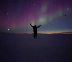 Rob silhouetted in the foreground of a landscaped Aurora Australis backdrop