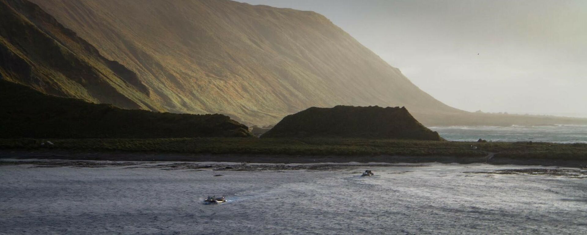 A LARC in the water and a helicopter in the air over Macquarie Island