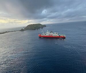 A ship in a bay near an island