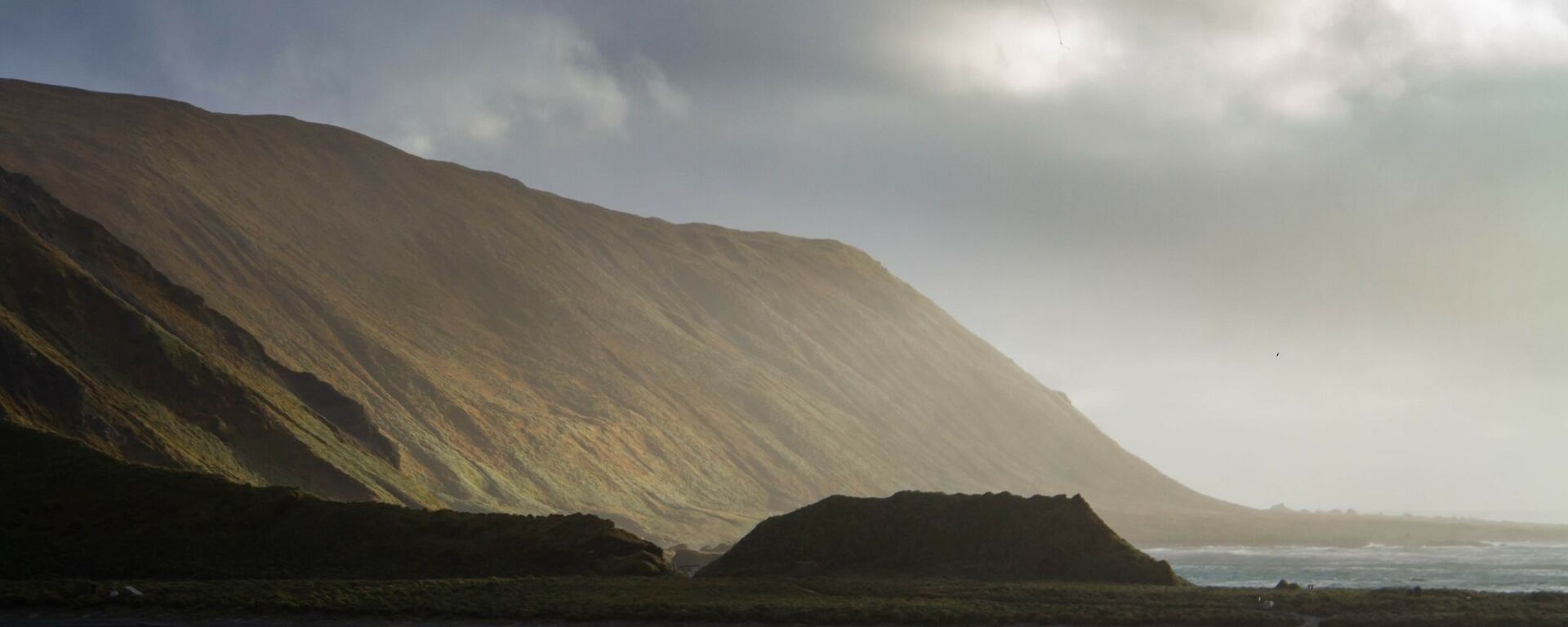 Sunlight on the side of a steep hillside