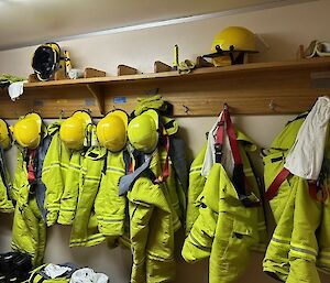 Fire gear ready to go hanging on pegs in one of the cold porches in the Rad Shed at Mawson station.