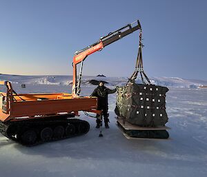 Braiden Richards with one of the airdrop loads on the Hiab crane ready for a sled to collect