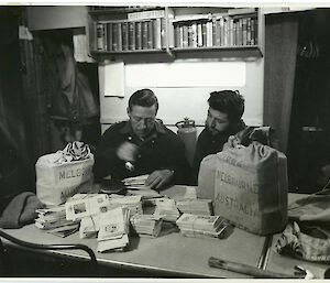 Postmaster franking mail at Mawson station in 1955