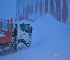 The Isuzu truck creating a lea for the driving snow of a blizzard at Mawson station this week