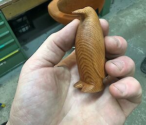 A carved wooden emperor penguin.