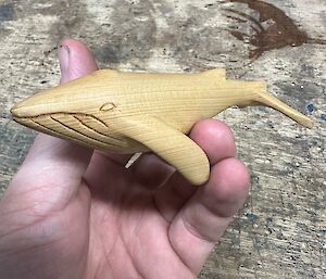 A carved, wooden humpback whale