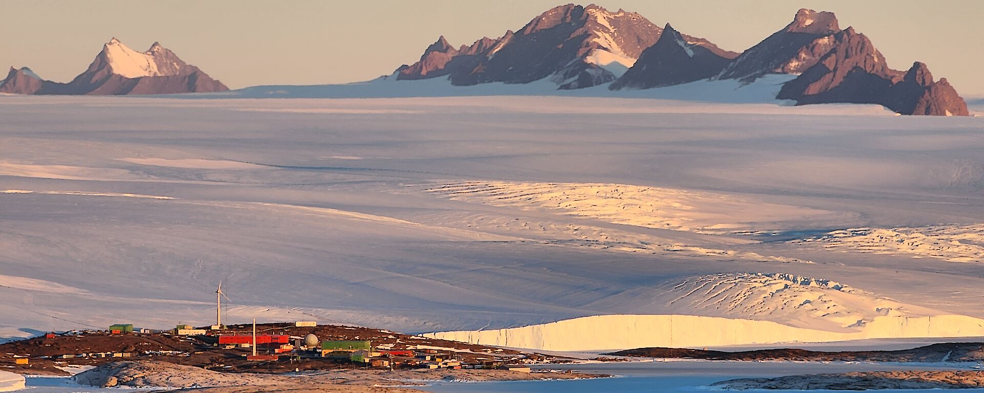 A view of Mawson station, the ice plateau and the Framnes Mts behind from Welch Island