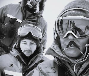 three expeditioners wearing stick on moustaches for some fun during the training session.