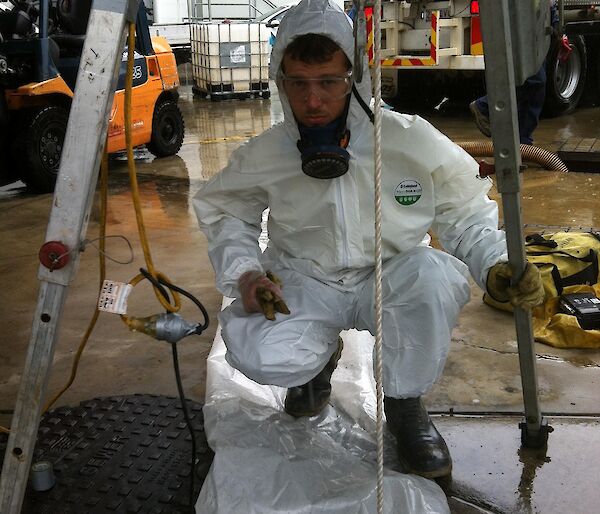 Mitch wears full PPE before entering confined space for a plumbing repair