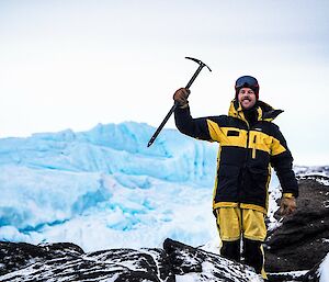 mitch with his ice axe and iceberg in backround