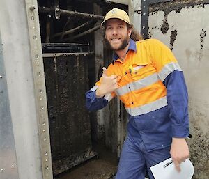 mitch in front of a plumbing element ready to be cleaned
