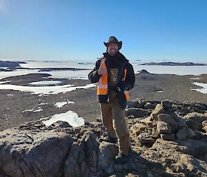 mitch stands atop a hill in the deep field