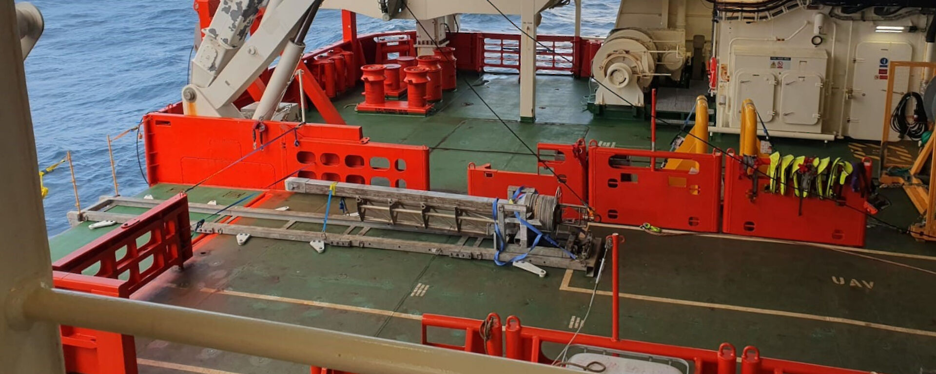 A metal coring instrument with a four metre-long barrel, sitting on the aft deck of Nuyina