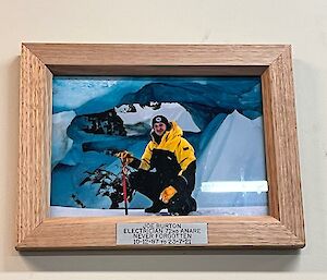A memorial on a wall with a wooden frame, to Joe Burton