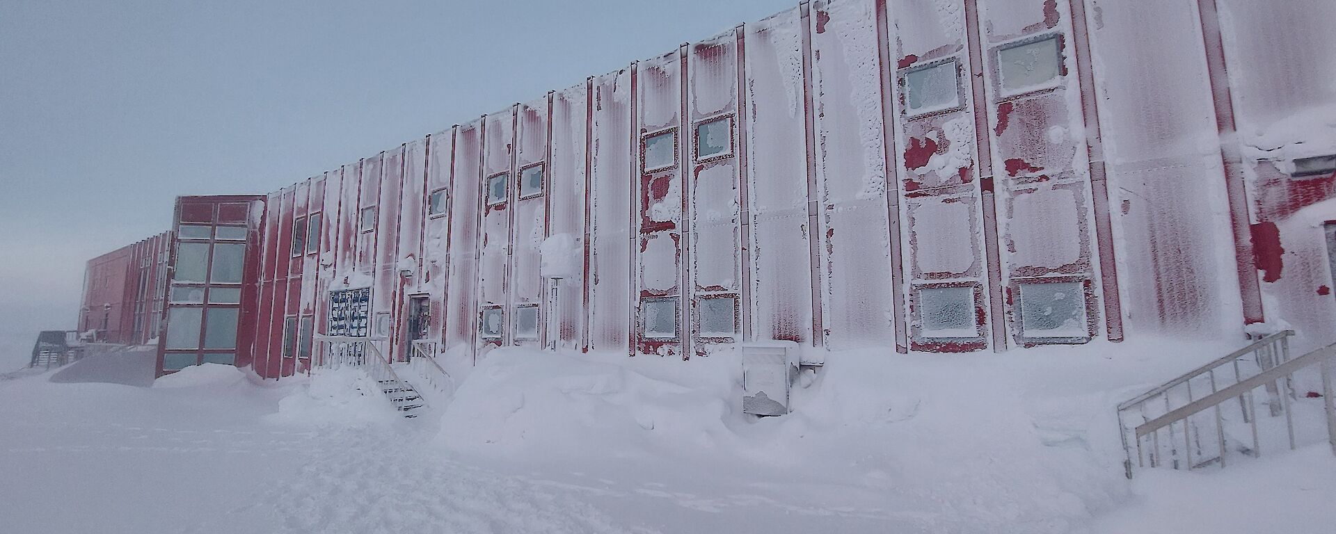 a photo of the red shed with a covered white snowed exterior
