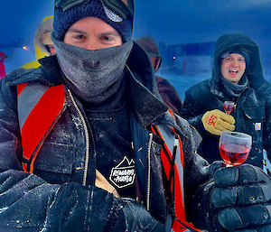 a neck buffed expeditioner and fellows toast the peak of the sun with a negroni