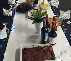 a photo showing the layout of the dinner table for the celebrations with cooked meals of expeditioners recipes