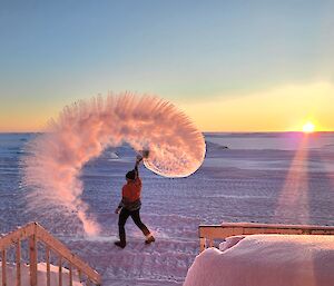 San throws a pot of boiling water into the air creating a cooling effect which turns water into vapour