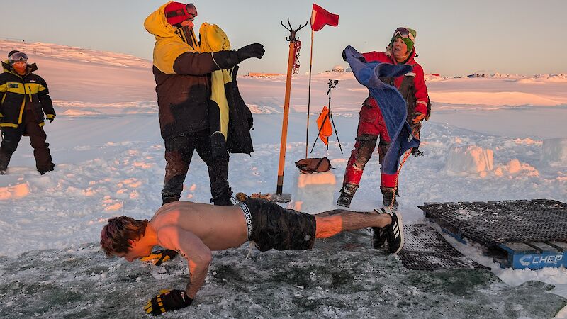 A man doing a push up in Antarctica