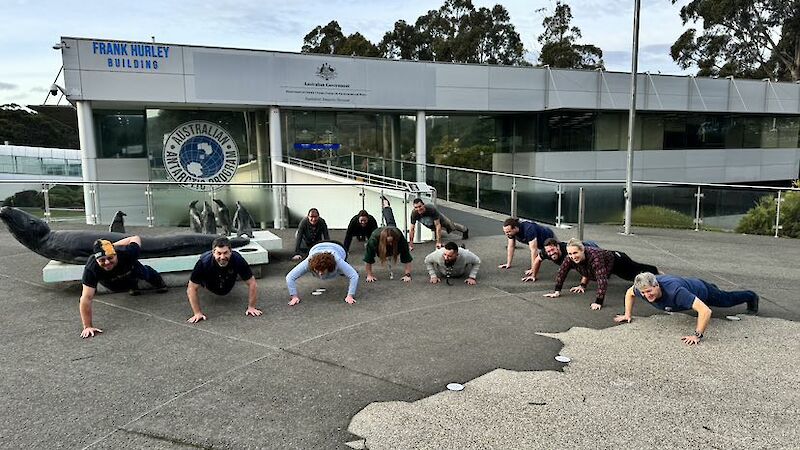 A group of staff members at the Australian Antarctic Division in Kingston doing push ups