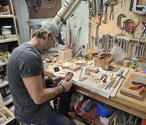 A carpenter working on his hobby material out of working hours at Mawson