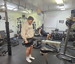 Two expeditioners in the gym at Mawson doing weights