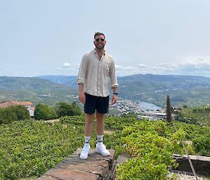Matt stands atop a vineyard that overlooks the local rivered valley of Porto in Portugal