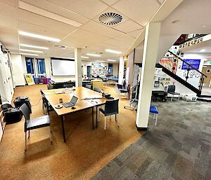 Room with carpet and desks set up with computers