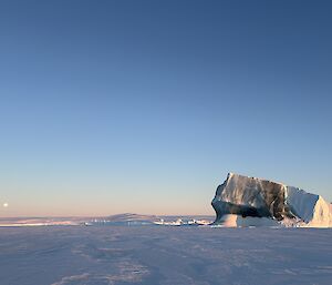 Jade-berg with the moon low on the horizon on the sea ice near Mawson recently