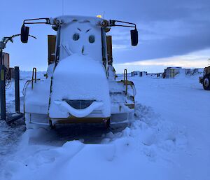 Plant equipment covered in snow, carved to look like a cartoon character