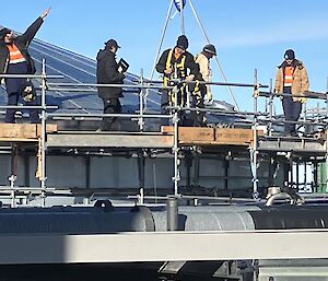 A group of people working on a water tank