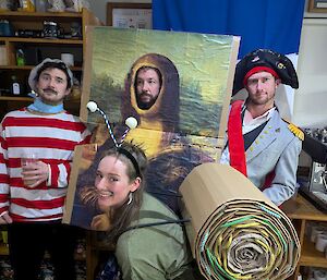 People dressed as a snail, traditional French man, Mona Lisa and Napoleon pose for the camera