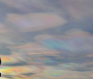 Rainbow coloured clouds above an Antarctic building