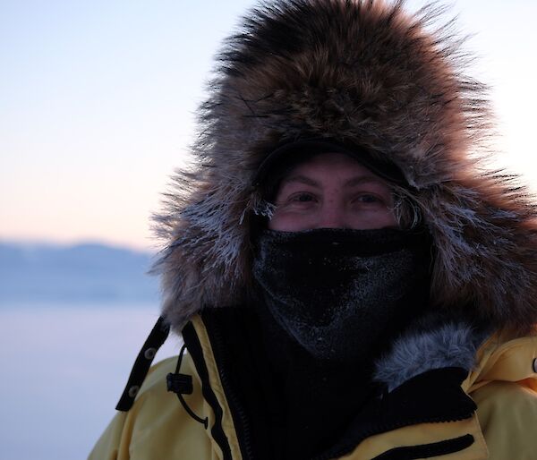 Expeditioner Peter Laughton wears cover mask and big wooly hat for a portrait taken on the sea ice during mid winter swim. A focused close shot with blurred backround