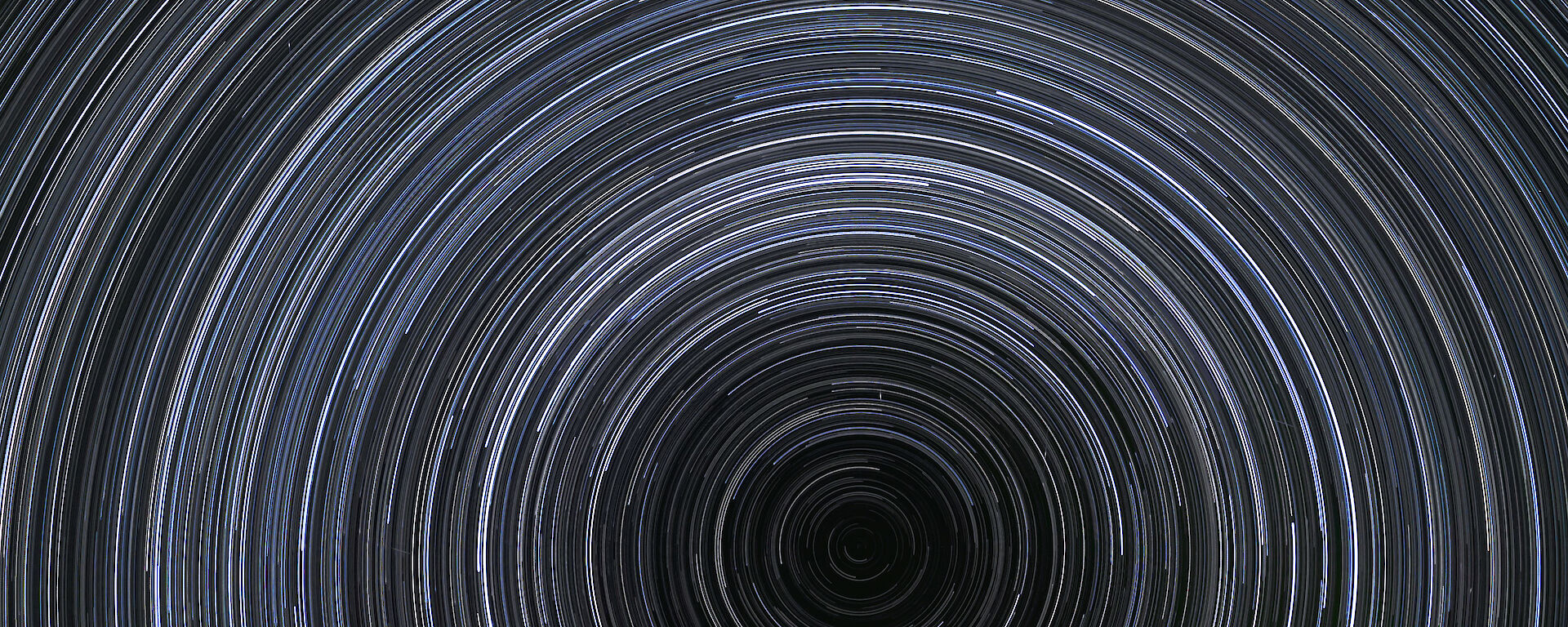 Star trails forming around the south celestial pole, marking an extension of the earth's axis of rotation