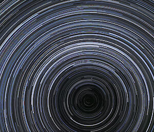 Star trails forming around the south celestial pole, marking an extension of the earth's axis of rotation