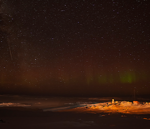 Orange light on a snowy slope with telecommunications equipment in sight