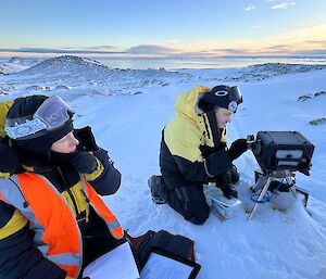 two communications officers Maintaining Bird Nesting Camera in the field