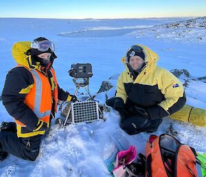 two communications officers Maintaining a Bird Nesting Camera in the field