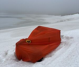 A red tent on a snowy slope