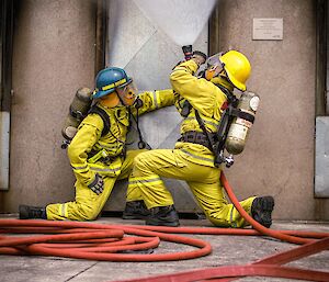 Expeditioners at Fire training in hobart pre-departure gas cooling a smoke filled door