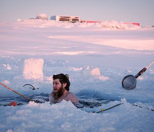 an expeditioner embraces the very cold waters during the June mid-winter swim