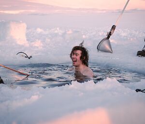 an expeditioner embraces the very cold waters during the June mid-winter swim