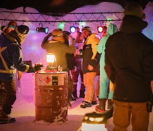Casey expeditioners pictured in the light filled outdoor ice bar