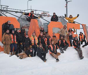 a group photo of some Casey trade staff  down by the Casey fuel farm sign