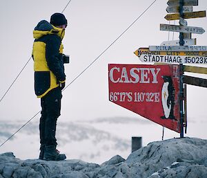 an expeditioner stands near the casey sign